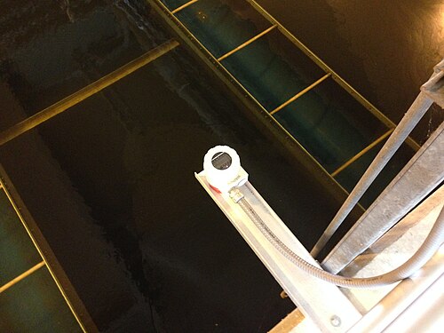 Ultrasonic level sensor installed above a tank at a water-treatment plant