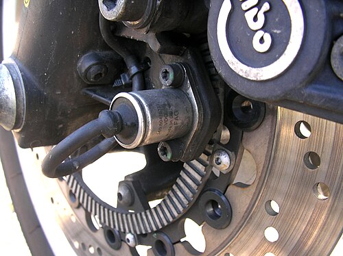 ABS wheel-speed sensor and toothed reluctor ring — a classic variable reluctance pickup